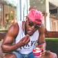 a boy in a pink cap with ice cream
